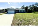 Newly constructed home with a two-car garage and spacious lawn at 1314 Hillsborough Ct, Poinciana, FL 34759