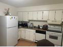 Kitchen with white cabinets and appliances at 1633 W Oak Ridge Rd # 1633B, Orlando, FL 32809