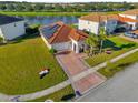 Single-Gathering home with solar panels and a brick driveway at 1651 Kingfisher Ct, Kissimmee, FL 34746