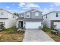 Two-story house with gray siding and a paved driveway at 4428 Kaipo Rd, Davenport, FL 33897