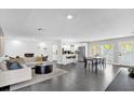 Open floor plan with living room, kitchen, and dining area at 8 Pine Ct, Yalaha, FL 34797