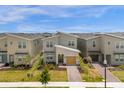 Modern two-story home with a yellow garage and landscaping in a residential area at 8940 Play Through Dr, Davenport, FL 33896