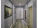 Inviting entryway with gray walls, wood-look flooring, and a large framed print at 3999 Night Heron Dr, Sanford, FL 32773