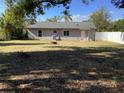 Large backyard with a fire pit and a white fence at 1111 South St, Eustis, FL 32726