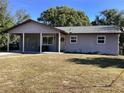 Gray house with a green roof, double doors, and a short walkway at 1111 South St, Eustis, FL 32726