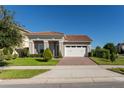 One story home with tile roof, two car garage, and landscaped yard at 13219 Stanthorne Ave, Orlando, FL 32832