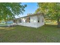 Side view of a white single story home with covered porch at 1405 Rose Blvd, Orlando, FL 32839