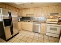 Bright kitchen featuring stainless steel appliances and light wood cabinets at 154 Lago Vista Blvd, Casselberry, FL 32707