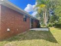 Brick house back view, with a patio and grassy backyard at 2355 Cypress Rd, Deland, FL 32724