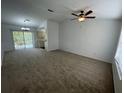 Spacious living room with carpeted floors and ceiling fan at 2355 Cypress Rd, Deland, FL 32724