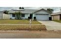 Front exterior view of a single-story home with a two-car garage at 310 Duke Ave, Altamonte Springs, FL 32714