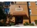 Condo building entrance with awning, showing address number 7500 at 7500 Toscana Blvd # 341, Orlando, FL 32819