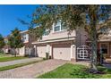 Attractive townhome with a two-car garage and well-manicured lawn at 8345 Bella Tierra Ct # 8345, Davenport, FL 33896