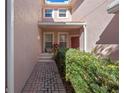 Brick walkway leads to front entrance with lush landscaping at 8345 Bella Tierra Ct # 8345, Davenport, FL 33896