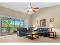 Spacious living room with high ceilings, leather sofas, and access to a screened balcony at 8345 Bella Tierra Ct # 8345, Davenport, FL 33896