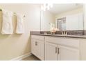 Modern bathroom with double vanity, granite countertop, and updated fixtures at 8943 Cabot Cliffs Dr, Davenport, FL 33896