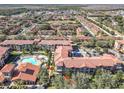 Aerial view showcasing condo location, community pool, and surrounding neighborhood at 904 Charo Pkwy # 525, Davenport, FL 33897