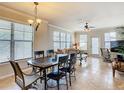 Bright dining area with tile flooring, large windows, and a six-chair table at 904 Charo Pkwy # 525, Davenport, FL 33897
