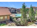 Community pool area with surrounding landscaping and building exterior visible at 904 Charo Pkwy # 525, Davenport, FL 33897