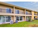 Townhome back with sliding glass doors leading to a patio and grass at 476 Lake Shore Pkwy, Davenport, FL 33896