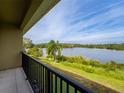 Balcony overlooking a serene lake and lush landscape at 476 Lake Shore Pkwy, Davenport, FL 33896