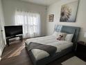 Bedroom with a large bed, a TV stand, and plenty of natural light at 612 Bloomingdale Dr, Davenport, FL 33897
