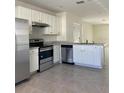 Modern kitchen with stainless steel appliances and white cabinets at 9000 Carlotta Way, Kissimmee, FL 34747