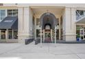 Modern building entrance with awning and access ramp at 100 S Eola Dr # 1411, Orlando, FL 32801