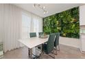 Dining area with white table, green chairs, and a green wall at 1251 Citrus Landing Blvd, Davenport, FL 33837