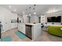 Modern kitchen with island, stainless steel appliances, and white cabinets at 1251 Citrus Landing Blvd, Davenport, FL 33837