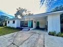 Front view of a charming home with a carport and well-maintained lawn at 1416 Bennett Rd, Orlando, FL 32803