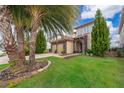 Two-story home with stone accents, palm trees, and a two-car garage at 15939 Vetta Dr, Bella Collina, FL 34756