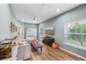 Spacious living room with L-shaped sofa, hardwood floors, and a view into the kitchen at 2920 Oak Park Way # Apt A, Orlando, FL 32822
