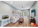 Bright living room featuring an L-shaped sofa and hardwood floors at 2920 Oak Park Way # Apt A, Orlando, FL 32822
