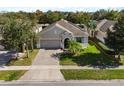 Single-Gathering home with a paved driveway and a well-manicured lawn at 12079 Alder Branch Loop, Orlando, FL 32824