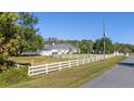 White fence surrounds the property with a view of the home at 19147 Quinella St, Orlando, FL 32833