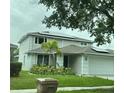 Two-story house with solar panels and landscaped lawn at 2912 Sunset Lakes Blvd, Kissimmee, FL 34747