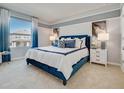 Spacious bedroom with a plush blue bed and large window at 3307 Private Oak Dr, Apopka, FL 32703