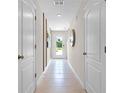 Neutral hallway with tile floors and access to bedrooms and back yard at 545 Zinfandel Dr, Holly Hill, FL 32117