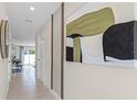 Bright and airy hallway with tile floors and modern wall art at 545 Zinfandel Dr, Holly Hill, FL 32117