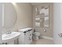 Small bathroom with a toilet, sink, and decorative wall art at 6018 Forest Perch Dr, St Cloud, FL 34771