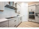 Modern kitchen with white cabinets and herringbone backsplash at 8264 Canetti St, Orlando, FL 32827