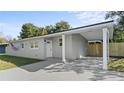 Newly renovated home with gray exterior, carport, and fenced yard at 1125 Murdock Blvd, Orlando, FL 32825