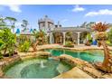 Enchanted pool area with a castle backdrop and stone fountain features at 14502 Scotch Pine Ct, Orlando, FL 32832