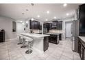 Spacious kitchen with an island, dark cabinetry, and quartz countertops at 3400 Stonewyck St, Orlando, FL 32824