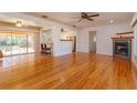Spacious living room featuring hardwood floors, a fireplace, and access to the kitchen at 4272 Kendrick Rd, Orlando, FL 32804