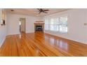 Hardwood floor living room with a fireplace and view to kitchen and hallway at 4272 Kendrick Rd, Orlando, FL 32804