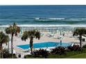 Oceanfront community pool with beach access and ample seating at 4501 S Atlantic Ave # 4090, New Smyrna Beach, FL 32169