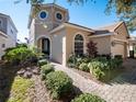 Two-story house with unique architectural details and professionally landscaped grounds at 8320 Via Bella Notte, Orlando, FL 32836