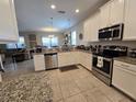Spacious kitchen featuring granite countertops and stainless steel appliances at 9037 Shadow Mountain St, Davenport, FL 33896